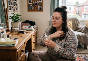 Woman applying hair serum